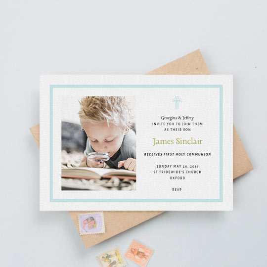 Communion Invitation - "Baby Blue Cross" A first holy communion invitation for a young boy. It has a baby blue border and blue crucifix. The card has a photo of a boy on the left. His name is written in a gold font
