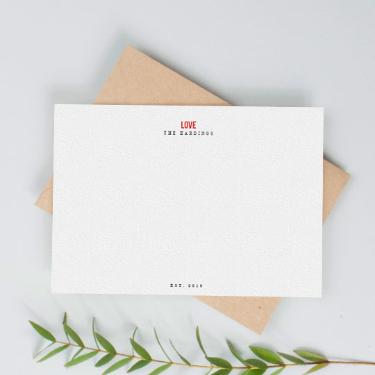 Personalised Correspondence Card - "Love" A white, personalised desk note card. It is personalised with the names of a couple and has the word “LOVE” printed in red at the top of the note card.